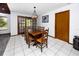 Traditional dining area boasting a wooden table set and a view into the connecting living room at 11203 Egret Nest Ct, Riverview, FL 33569