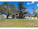 Charming two-story home with blue double-door entrance, mature landscaping and healthy green grass at 11203 Egret Nest Ct, Riverview, FL 33569