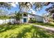 Charming two-story home with blue double-door entrance, mature landscaping and healthy green grass at 11203 Egret Nest Ct, Riverview, FL 33569