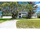 Charming two-story home with blue double-door entrance, mature landscaping and healthy green grass at 11203 Egret Nest Ct, Riverview, FL 33569