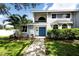 Charming two-story home with blue double-door entrance, mature landscaping and healthy green grass at 11203 Egret Nest Ct, Riverview, FL 33569