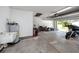 Large garage space with storage, laundry, and a motorcycle parked near the open door at 11203 Egret Nest Ct, Riverview, FL 33569