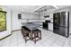 Functional kitchen with sleek black appliances, a breakfast bar, ample cabinet space, and tile flooring at 11203 Egret Nest Ct, Riverview, FL 33569