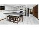 Modern kitchen with stainless steel appliances, breakfast bar with seating, and white cabinetry at 11203 Egret Nest Ct, Riverview, FL 33569