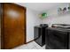 Laundry room featuring modern black washer and dryer with wire shelving for storage at 11203 Egret Nest Ct, Riverview, FL 33569