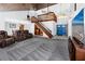 Expansive living room featuring vaulted wood ceilings, staircase, and a comfortable leather seating arrangement at 11203 Egret Nest Ct, Riverview, FL 33569