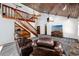 Living room with a wood ceiling, wood staircase, built-in shelves, and comfortable brown leather seating arrangement at 11203 Egret Nest Ct, Riverview, FL 33569