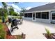 Spacious patio with outdoor grill and dining set adjacent to a screened-in porch offers inviting outdoor living at 11203 Egret Nest Ct, Riverview, FL 33569