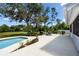 Backyard featuring a pool, patio, and green grass under mature trees offers a serene setting at 11203 Egret Nest Ct, Riverview, FL 33569