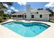 Beautiful in-ground swimming pool surrounded by a concrete patio and a well-manicured backyard at 11203 Egret Nest Ct, Riverview, FL 33569