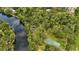 Picturesque aerial view of community amenities, including a lake, park, and tennis court at 11501 Cerca Del Rio Pl, Temple Terrace, FL 33617