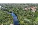 Scenic aerial view of the community with a river, tennis court, and lush landscaping at 11501 Cerca Del Rio Pl, Temple Terrace, FL 33617