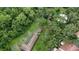 Overhead shot of tile roof home nestled among lush, mature trees and manicured landscaping at 11501 Cerca Del Rio Pl, Temple Terrace, FL 33617