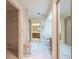 Clean, bright bathroom with white tile, walk-in shower, vanity and toilet in separate area at 11501 Cerca Del Rio Pl, Temple Terrace, FL 33617
