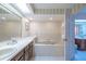 Bathroom with vanity, soaking tub, white ceramic tile, and walk-in shower at 11501 Cerca Del Rio Pl, Temple Terrace, FL 33617
