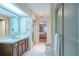 Bathroom with vanity, walk-in shower, ceramic tile and access to bedroom and hallway at 11501 Cerca Del Rio Pl, Temple Terrace, FL 33617