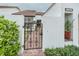 Charming front yard with a decorative wrought iron gate and beautiful landscaping at 11501 Cerca Del Rio Pl, Temple Terrace, FL 33617