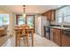 Eat-in kitchen featuring a bright breakfast area, classic cabinetry, and tile flooring at 11501 Cerca Del Rio Pl, Temple Terrace, FL 33617
