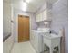 Functional laundry room offering a washer, dryer, storage cabinetry, and a utility sink at 11501 Cerca Del Rio Pl, Temple Terrace, FL 33617