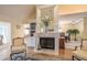 Elegant fireplace with white mantle, flanked by built-in shelves and views of the dining area at 11501 Cerca Del Rio Pl, Temple Terrace, FL 33617