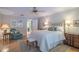 Serene main bedroom with hardwood floors, a ceiling fan, and en-suite bathroom access at 11501 Cerca Del Rio Pl, Temple Terrace, FL 33617