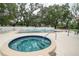 Community pool area with a hot tub, swimming pool, and lounge chairs for relaxation at 11501 Cerca Del Rio Pl, Temple Terrace, FL 33617