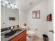 Stylish half bathroom with a dark marbled countertop and decorative fixtures at 11729 Newberry Grove Loop, Riverview, FL 33579