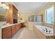 Bathroom with a vanity, built in cabinet, bathtub, and a glass-enclosed shower at 11729 Newberry Grove Loop, Riverview, FL 33579