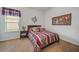 Cozy bedroom featuring a comfortable bed with red accents and a bedside table at 11729 Newberry Grove Loop, Riverview, FL 33579