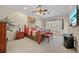 Bedroom with a canopy bed, large window with shutters, seating bench, and a media cabinet at 11729 Newberry Grove Loop, Riverview, FL 33579