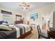 Comfortable bedroom features ceiling fan, desk and a door leading to the ensuite bathroom at 11729 Newberry Grove Loop, Riverview, FL 33579
