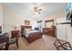 Comfortable bedroom with a ceiling fan, plush carpet, and a dresser with mirror at 11729 Newberry Grove Loop, Riverview, FL 33579