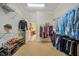 Walk-in closet with shelving, hanging racks filled with clothes, shoes, and accessories at 11729 Newberry Grove Loop, Riverview, FL 33579