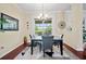 Dining area with modern light fixture, neutral color scheme, and large windows with outdoor views at 11729 Newberry Grove Loop, Riverview, FL 33579