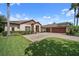Stunning house featuring a three-car garage, stone accents, and tile driveway at 11729 Newberry Grove Loop, Riverview, FL 33579