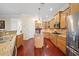 Gourmet kitchen with stainless steel appliances, granite countertops, and custom wood cabinetry at 11729 Newberry Grove Loop, Riverview, FL 33579