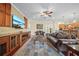 Spacious living room with hardwood floors, cozy furniture, and a large entertainment center at 11729 Newberry Grove Loop, Riverview, FL 33579