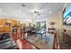 Comfortable living room with hardwood floors, ceiling fan, and sliding glass doors to the patio at 11729 Newberry Grove Loop, Riverview, FL 33579