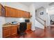 Home office with wooden cabinets, a desk, and a view of a carpeted staircase at 11729 Newberry Grove Loop, Riverview, FL 33579