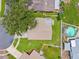 An aerial view of the home highlighting the backyard, landscaping, and surrounding neighborhood at 12156 Meadowbrook Ln, Largo, FL 33774