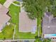 Aerial view of the property showcasing the roof, yard, and surrounding neighborhood with mature trees at 12156 Meadowbrook Ln, Largo, FL 33774