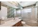 Bathroom features a shower and tub combo, patterned wallpaper, and single sink vanity at 12156 Meadowbrook Ln, Largo, FL 33774