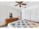 Bedroom features white walls, carpeted flooring, a ceiling fan, and storage at 12156 Meadowbrook Ln, Largo, FL 33774
