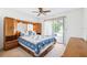 Bedroom features sliding glass doors and a wooden bed frame at 12156 Meadowbrook Ln, Largo, FL 33774