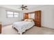 Bright bedroom featuring neutral carpet, a ceiling fan, and a built-in headboard and wardrobe at 12156 Meadowbrook Ln, Largo, FL 33774