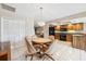 Eat-in dining area features a chandelier and transitions into the kitchen with wooden cabinetry at 12156 Meadowbrook Ln, Largo, FL 33774