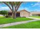 Charming single-Gathering home with mature trees, a well-manicured lawn, and an attached two-car garage at 12156 Meadowbrook Ln, Largo, FL 33774