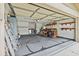 Spacious garage featuring laundry area, ample storage space, and an open garage door at 12156 Meadowbrook Ln, Largo, FL 33774