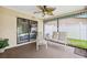 Relaxing screened lanai offering a comfortable seating area and views of the fenced backyard at 12156 Meadowbrook Ln, Largo, FL 33774