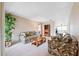 Spacious living room with comfortable furniture, a large houseplant, and an open layout at 12156 Meadowbrook Ln, Largo, FL 33774